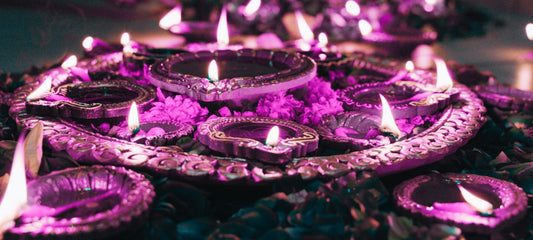 A collection of candles celebrating Diwali in a purple filter.